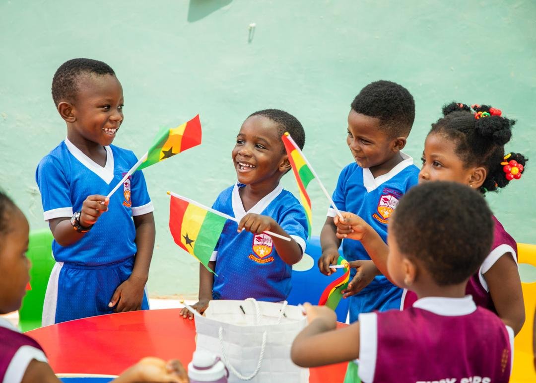 Pupils celebrating Ghana's Independence Day with flags